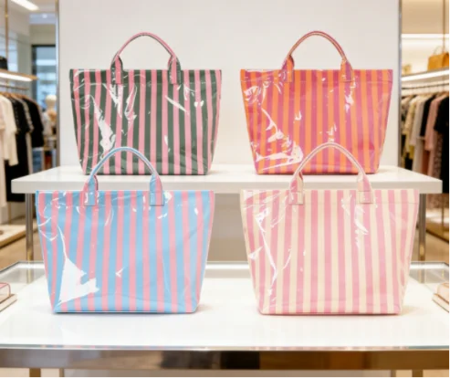 Colorful striped PVC tote bags displayed on a retail shelf.