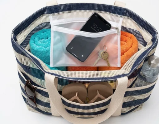 Top-down view of an organized striped mesh tote with waterproof pocket.
